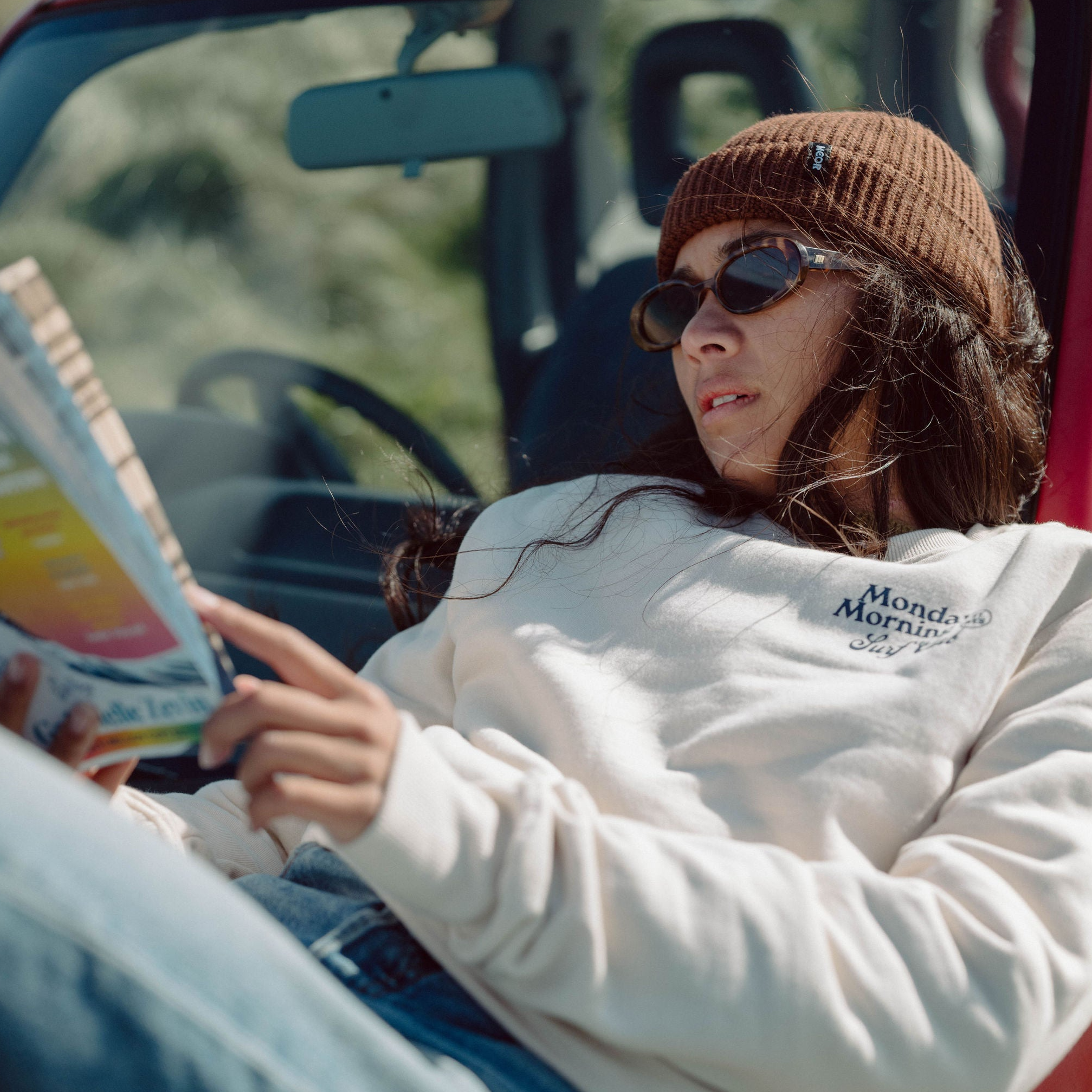 Woman wearing Organic Monday Morning Surf Club Sweatshirt and recycled St Ives Harbour Beanie by Meor Apparel